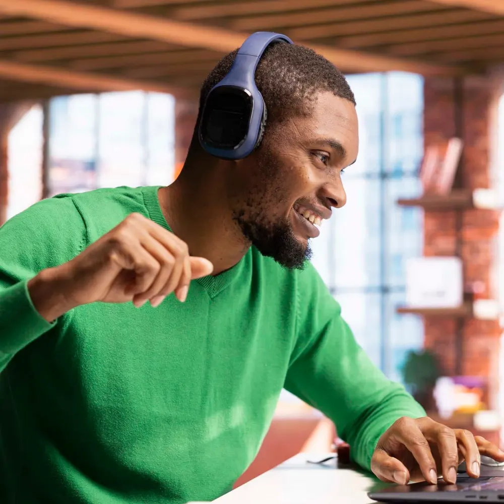Medewerker met headset werkt geconcentreerd aan zijn laptop